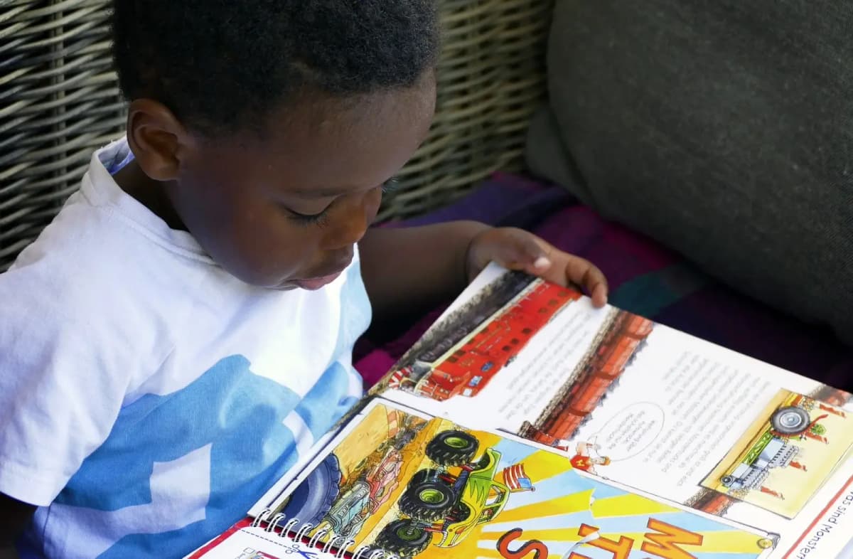 Child reading a book at home
